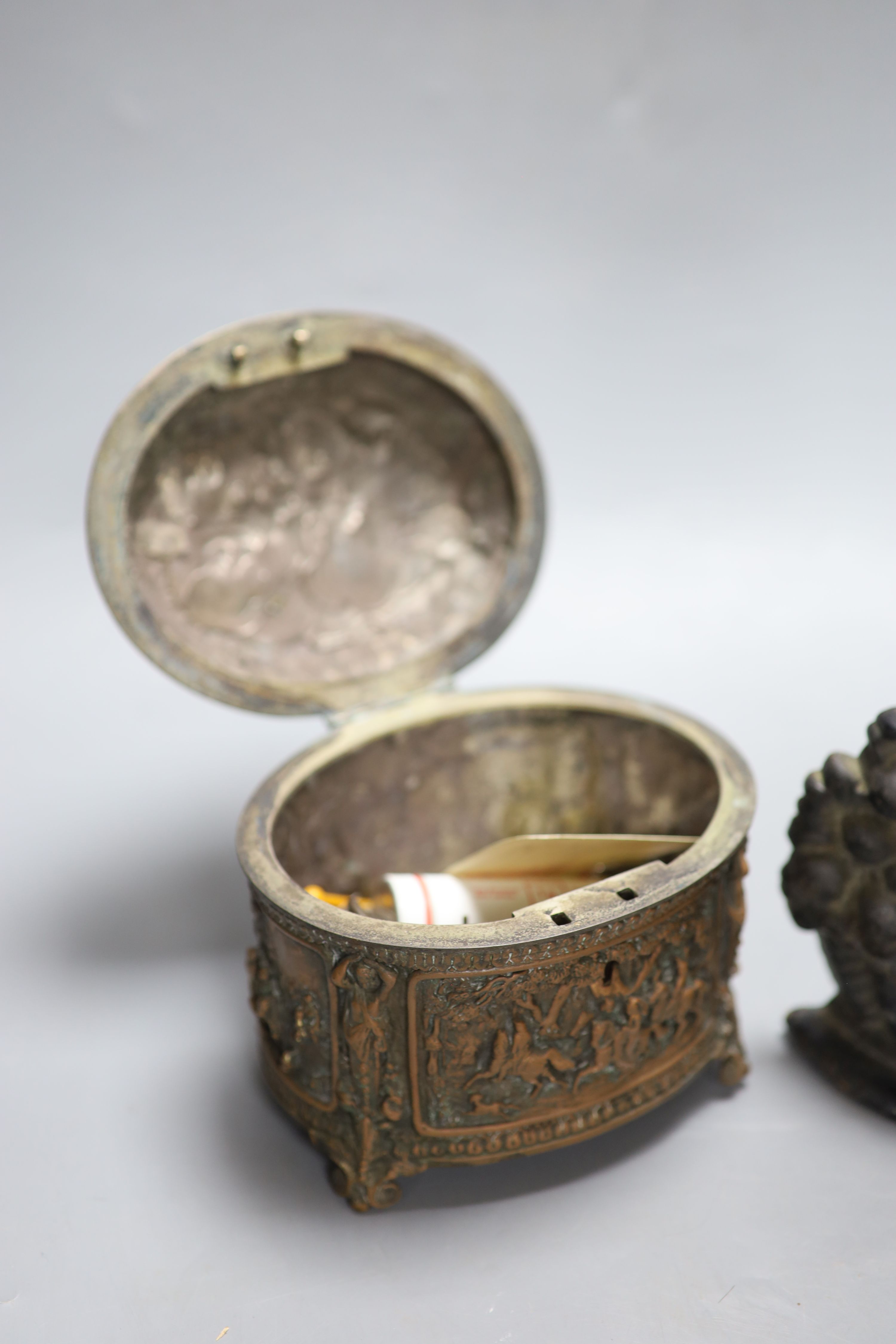 A Victorian black painted cast iron door stop, height 36cm, and a Victorian cast copper lidded casket